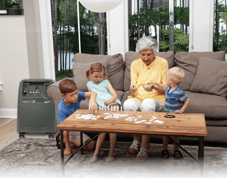 Grandma playing with her grandchildren while using the Caire Visionaire 5 Oxygen Concentrator. Shop now at Zone Medical.