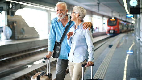 Inogen Rove 6 Portable Oxygen Concentrator old couple at train station carrying the device with the shoulder strap bag. Shop now at Zone Medical.