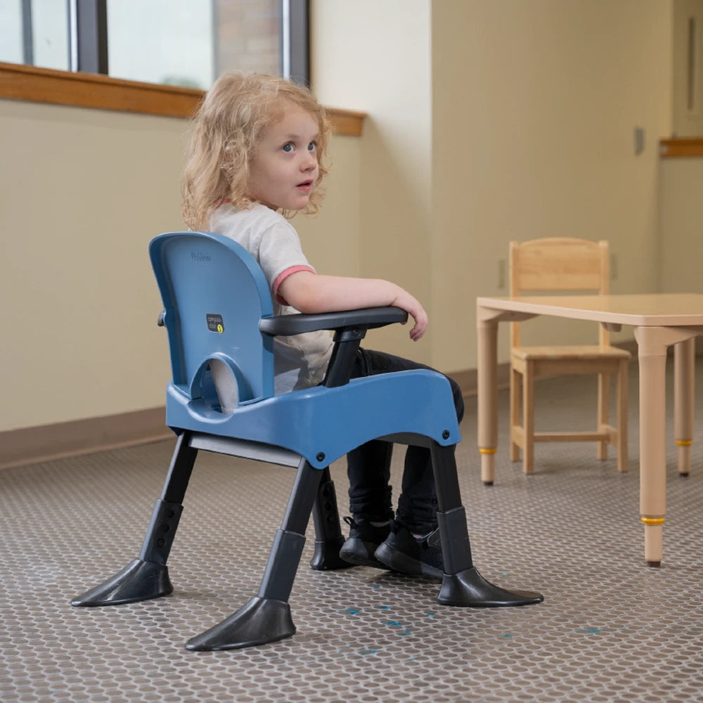 Rifton Compass Chair a child sitting on it with the stability feet. Shop now at Zone Medical.